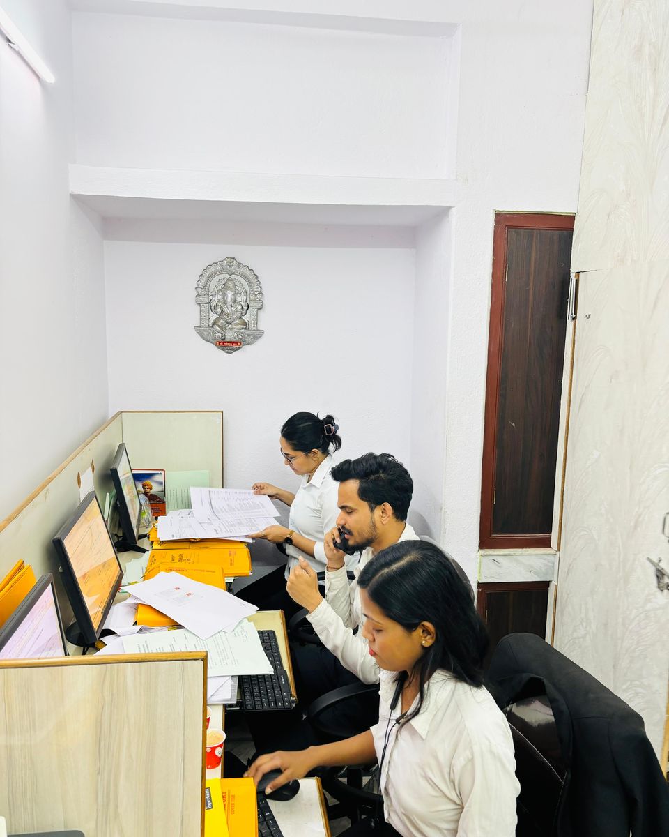 The client care team working together at their shared desk.