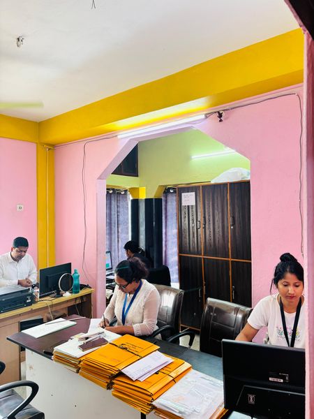 A view through the office archway to staff working through matter files.