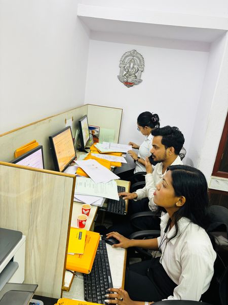 A member of the client care team on the phone at her workstation.