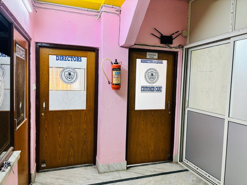 The corridor to the Directors' office and the marketing, legal and customer care room, each door marked with the Steadyshield seal.