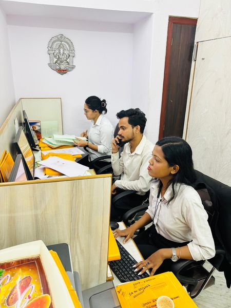 Three members of the client care team working at their desks.